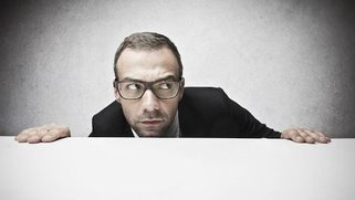 A man looking out over a desk