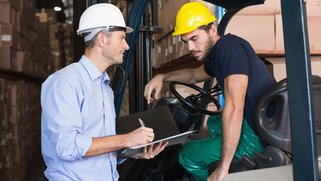 Forklift and two coworkers discussing tasks