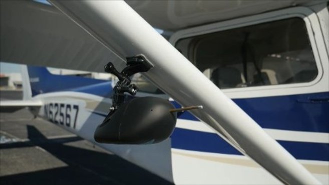 Picture of a wingBug device mounted to the wing of an airplane.